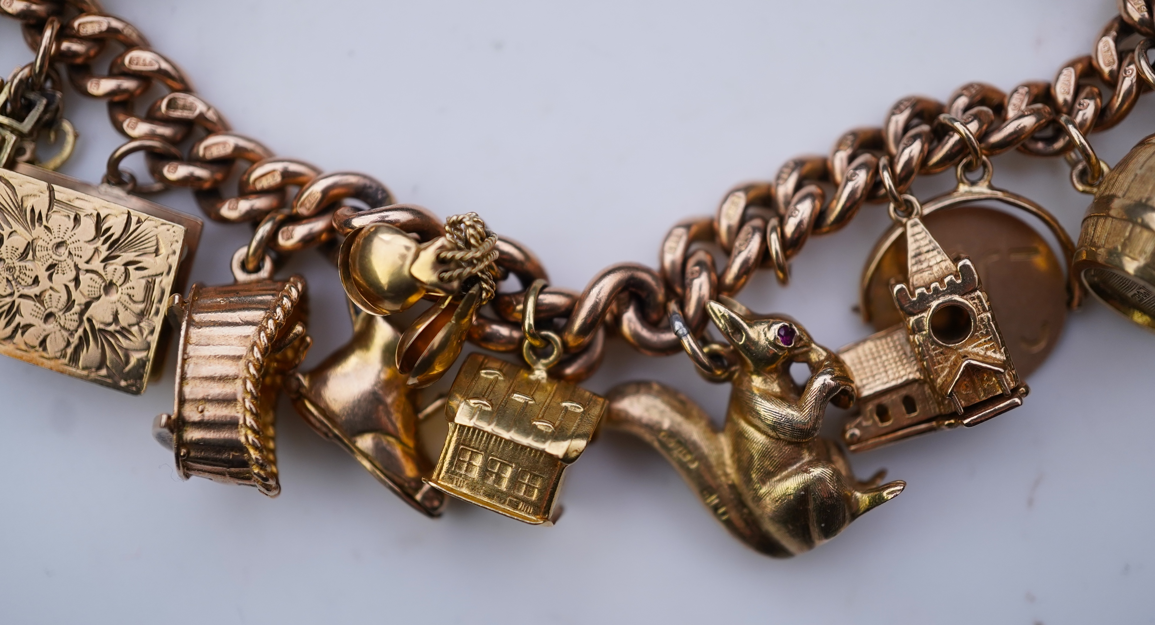 A 9ct gold charm bracelet, mid 20th century